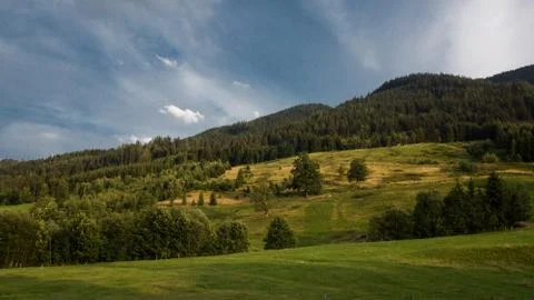Dramatic sky over meadow hill Stock Photos
