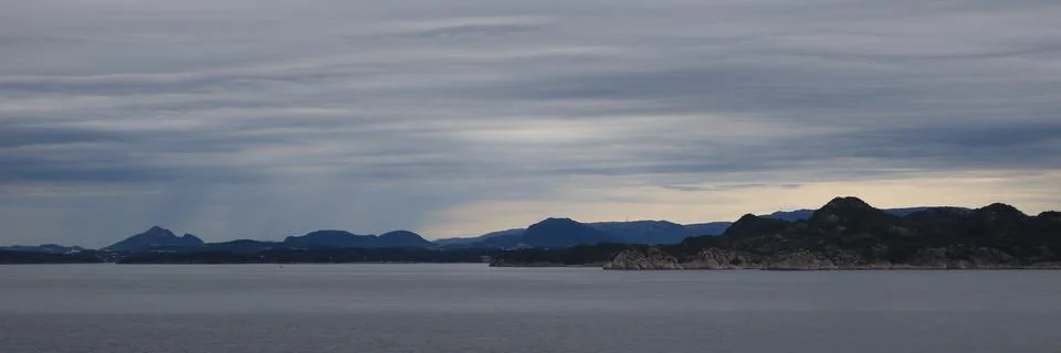 Dramatic sky over mountain ranges near Bergen, Norway. Stock Photos