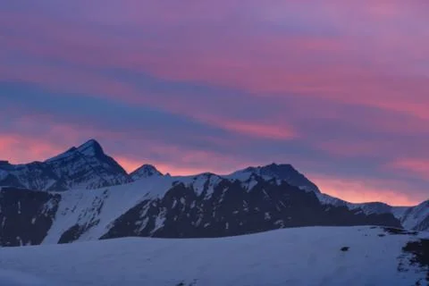 Dramatic sky over mountain silhouette Stock Photos