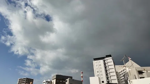 Dramatic Sky over Okinawa: Rain Clouds Above City Buildings Stock Footage 299957286