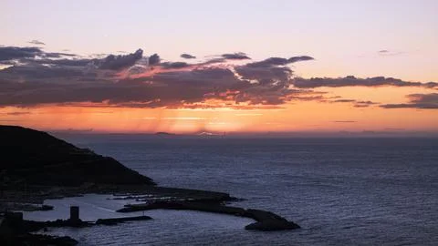 Dramatic sky over the sea at sunset. Sardinia, Italy Stock Photos