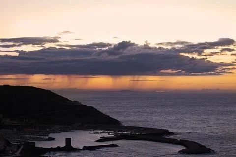 Dramatic sky over the sea at sunset. Sardinia Stock Photos