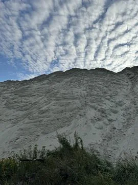 Dramatic sky over a textured white hillside Stock Photos