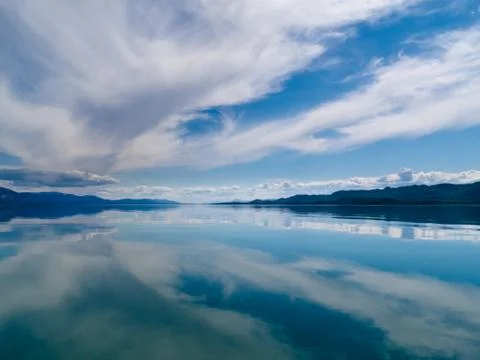 Dramatic sky reflected on calm lake Stock Photos