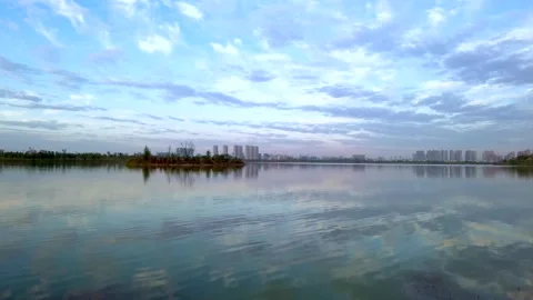 The dramatic sky is reflected on the lake Stock Footage 300577886