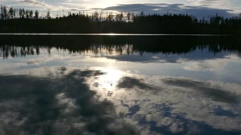Dramatic sky reflected in the still waters of a forest lake in Sweden. Stock Footage 318196123
