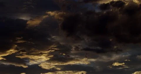 Dramatic sky with richly illuminated clouds at the day’s magic hour. Stock Photos