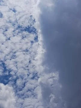 Dramatic sky showing dark storm clouds moving in to cover bright white clouds, Stock Photos