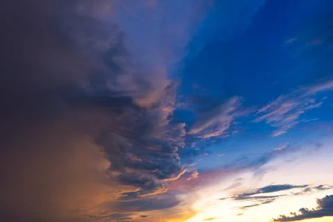 Dramatic sky with storm cloud before raining during sunset. Stock Photos