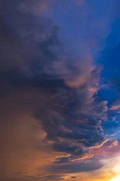 Dramatic sky with storm cloud before raining during sunset. Stock Photos