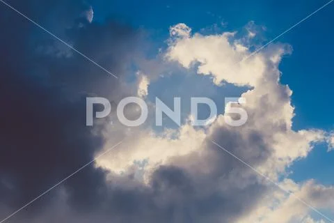Dramatic sky with stormy clouds and sunlight Stock Photos