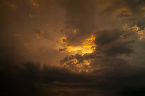 Dramatic sky with stormy clouds at sunset. Nature background. Stock Photos