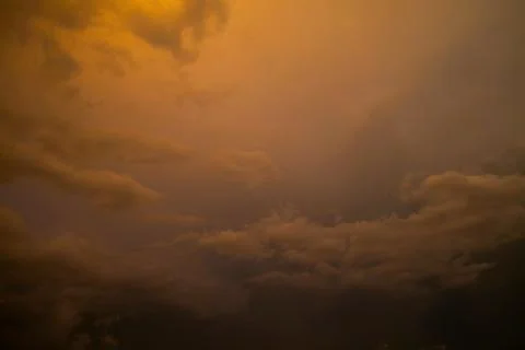 Dramatic sky with stormy clouds at sunset. Nature background. Stock Photos