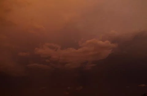 Dramatic sky with stormy clouds at sunset. Nature background. Stock Photos