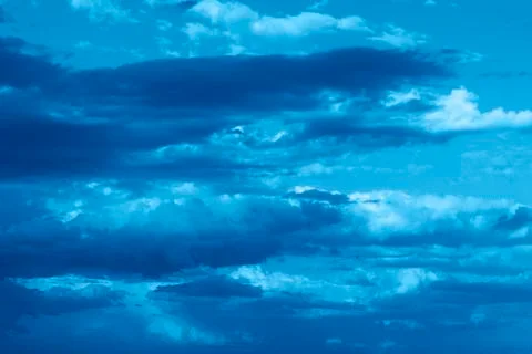 Dramatic sky with stormy clouds. Trendy color of the year 2020. Stock Photos