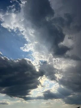 Dramatic Sky with Sun Rays Breaking Through Dark Clouds 写真素材