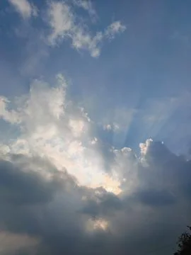 Dramatic Sky With Sun Rays Breaking Through Clouds Over Blue Horizon At Sunset Fotos Stock