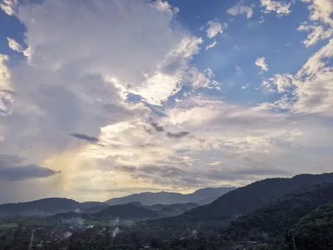 Dramatic Sky with Sunlight Beam over Mountain Stock Photos
