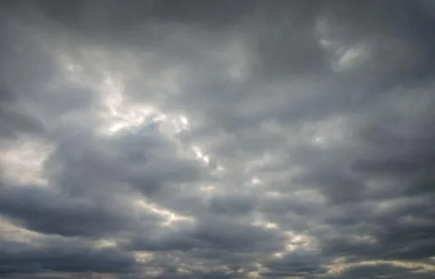 Dramatic sky with sunlight showing thru them Stock Photos