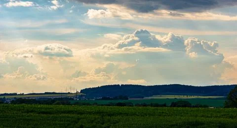 Dramatic sky with sunrays breaking through storm clouds Stock Photos