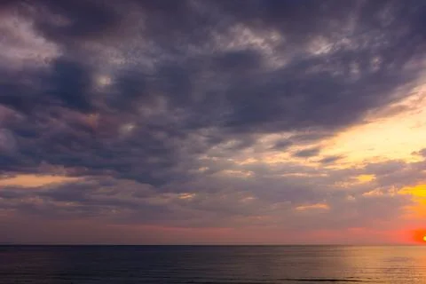 Dramatic sky at sunrise at the sea Stock Photos