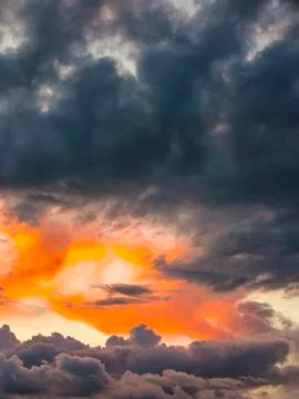 Dramatic sky with sunset and dark rainy clouds Stock Photos
