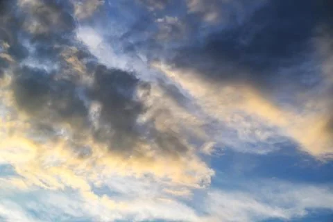 Dramatic sky at sunset with dark storm clouds and golden light 스톡 사진