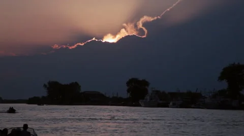 Dramatic sky sunset or sunrise on river, boats silhouette Stock Footage 49680129