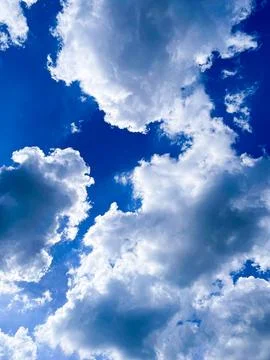 Dramatic sky with thick clouds against blue sky Stock Photos