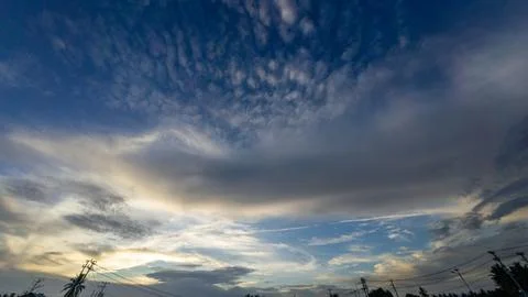 Dramatic Sky with Wispy Clouds and Silhouetted Power Lines Stock Photos