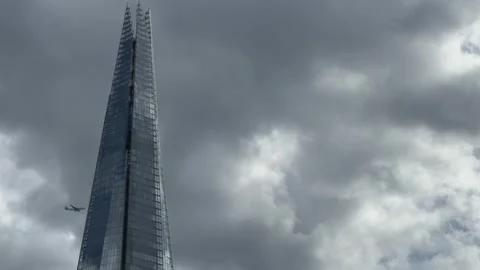 Dramatic Skyscraper Against Overcast Sky: Modern Urban Architecture Stock Footage 315219133