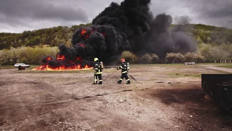 Dramatic slow motion of 2 firemen getting ready for their training Stock Footage 233654791