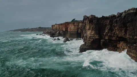 Dramatic Slow Motion of Atlantic Ocean Waves Crashing Against Steep Cliffs in Stock Footage 327612191