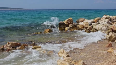 Dramatic slow motion scene of waves crashing on a rocky shore Stock Footage 298566629