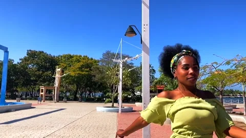 Dramatic slow motion shot of Afro Cuban woman dancing in a park Stock Footage 259994594