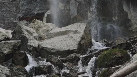 Dramatic Slow Motion  tilt up from pure mountain stream to powerful waterfall Stock Footage 81420057