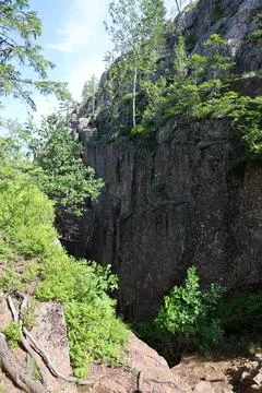 Dramatic Slttdalsskrevan gorge with towering rock walls and hiking trail in t Stock Photos