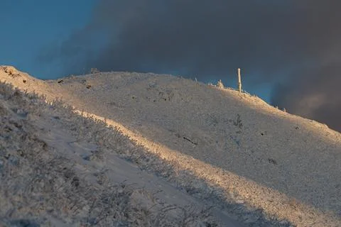 The dramatic Smerek peak in the Bieszczady Mountains covered in snow and ri.. Stock Photos