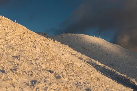 The dramatic Smerek peak in the Bieszczady Mountains covered in snow and ri.. Stock Photos