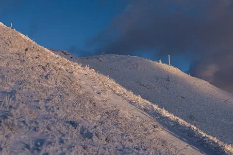 The dramatic Smerek peak in the Bieszczady Mountains covered in snow and ri.. Stock Photos