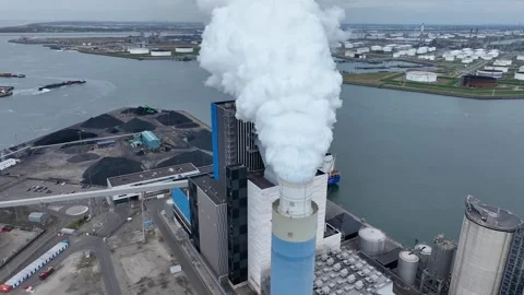 Dramatic smoke from a chimney, an industrial plant in city aerial view Stock Footage 309923233