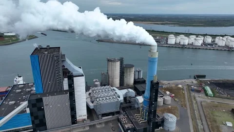 Dramatic smoke from a chimney, an industrial plant in city aerial view Stock Footage 332077536