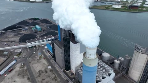 Dramatic smoke from a chimney, an industrial plant in city aerial view Stock Footage 332680804