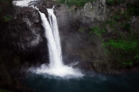 Dramatic Snoqualmie Falls in Washington drops into a vibrant blue pool below. Photos