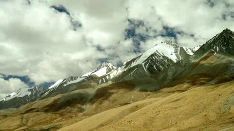 Dramatic snow capped mountains with fast clouds time lapse Stock Footage 282195133