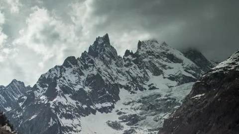 Dramatic Snow-Capped Peaks Under Overcast Sky in 4K UHD Stock-Footage 329199908