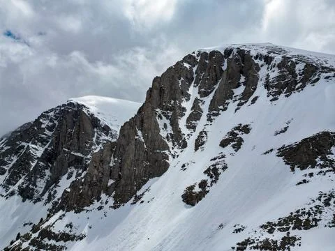 Dramatic Snow-Covered Mountain Peak Rocky Ridge Clouds Aerial Stock Photos