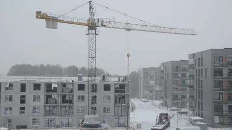 Dramatic snowstorm and construction site workers builders work Stock Footage 48171380