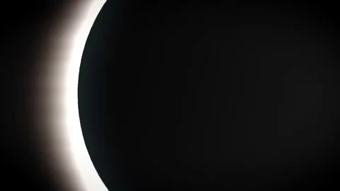 Dramatic solar eclipse scene with bright lens flare and celestial atmosphere, Stock Footage 328699419