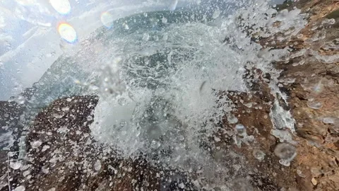 A dramatic spherical perspective of waves crashing into jagged rocks with the Stock Footage 294109534